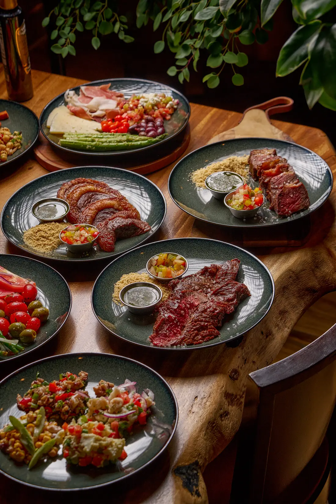 A table set with cuts, salads and sides for a business dinner